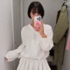 Model wearing Korean-style pleated skirt pants, perfect for spring fashion and casual office wear (1).