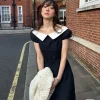 Woman wearing a Korean-style off-shoulder spring dress in a garden (1)