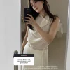 Woman wearing a light drape shirt and A-line skirt, perfect for summer fashion and casual elegance (1).