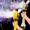 Child holding a handheld light-up bubble machine with colorful bubbles floating outdoors (1).