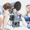 Baby chair seated in a grey portable chair with sun canopy, designed for indoor and outdoor use (3).