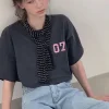 Woman wearing retro letter print short sleeve tee on urban street (2).