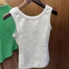 Woman wearing RE*TO 2025 retro tank top outdoors on a sunny day (1).