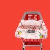 Baby sitting in a cotton PILLANI shopping cart cover inside a grocery cart (3).