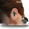 Invisible X55 wireless sleep earbuds next to a pillow and phone (1).